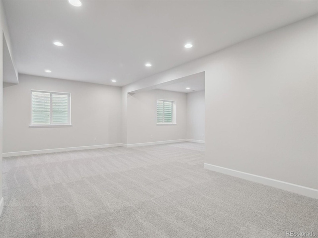 basement featuring light carpet