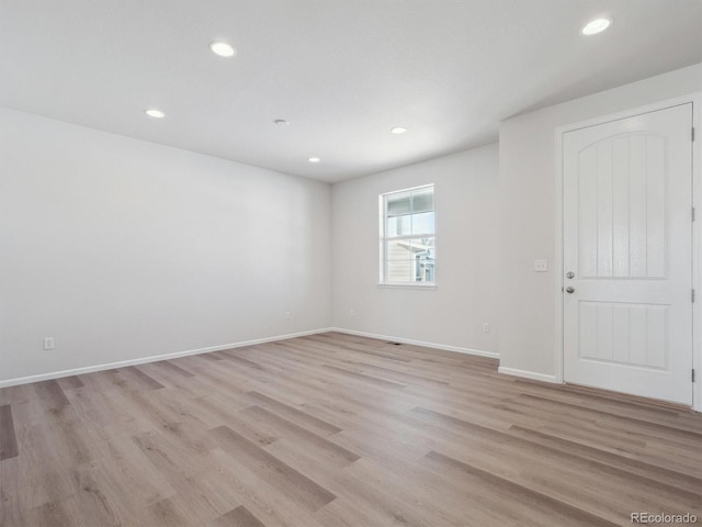 spare room with light wood-type flooring