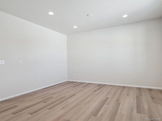 spare room featuring light hardwood / wood-style flooring