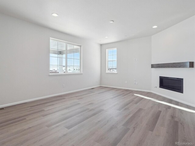 unfurnished living room with light wood-type flooring