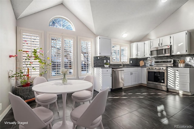 kitchen with white cabinetry, appliances with stainless steel finishes, sink, and decorative backsplash