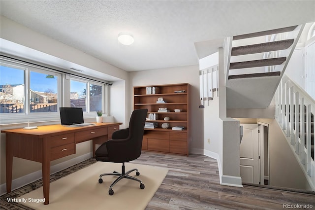 office featuring dark wood-type flooring and a textured ceiling