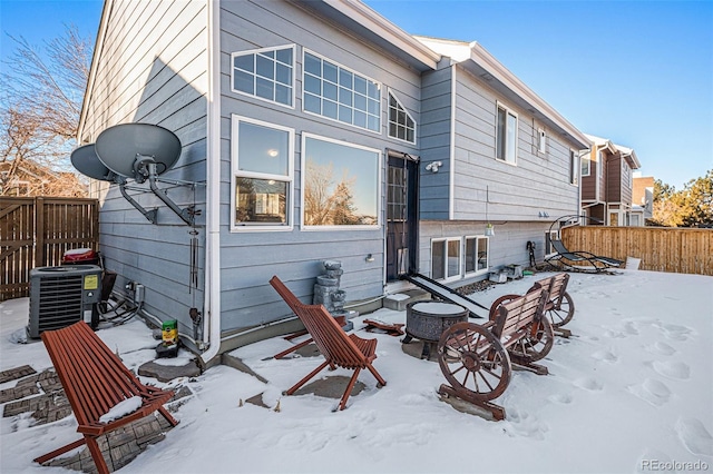 snow covered property featuring cooling unit