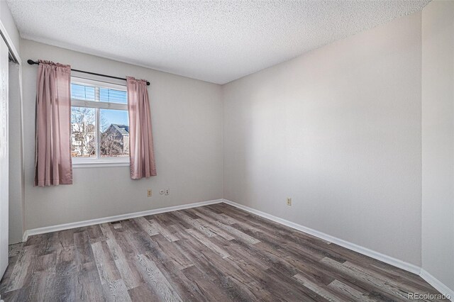 3738 Rosewalk Ct, Highlands Ranch, CO 80129 - spare room with wood finished floors, a textured ceiling, and baseboards