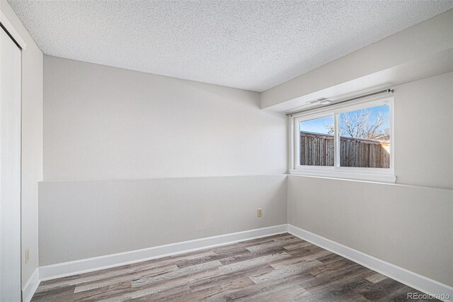 3738 Rosewalk Ct, Highlands Ranch, CO 80129 - spare room with wood finished floors, a textured ceiling, and baseboards