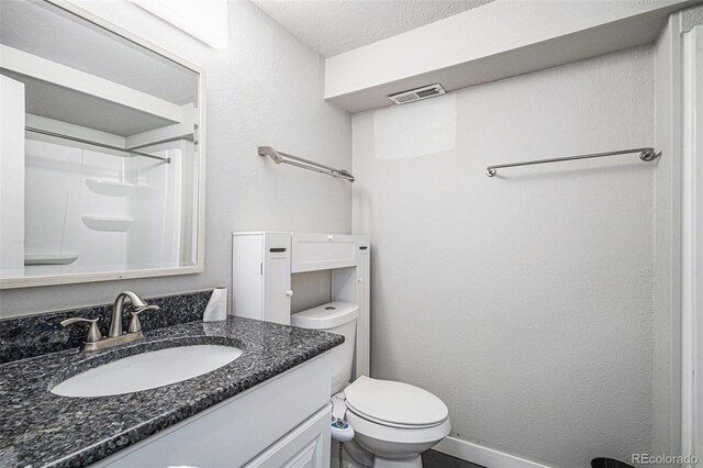 3738 Rosewalk Ct, Highlands Ranch, CO 80129 - bathroom featuring vanity, toilet, a shower, and a textured ceiling
