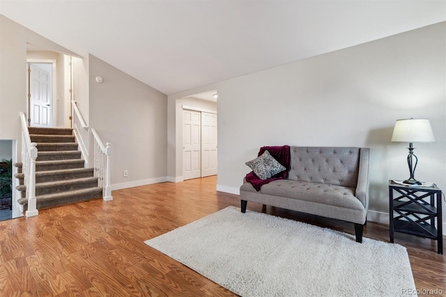 living room featuring wood-type flooring and lofted ceiling