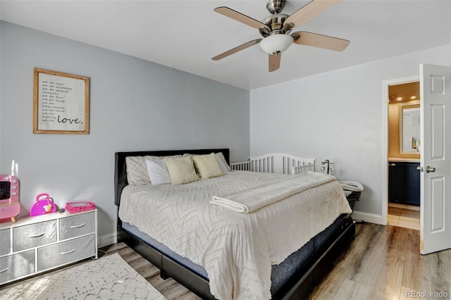 bedroom featuring ceiling fan, wood-type flooring, and ensuite bath