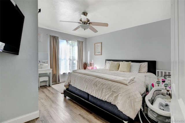 bedroom with light wood-type flooring and ceiling fan