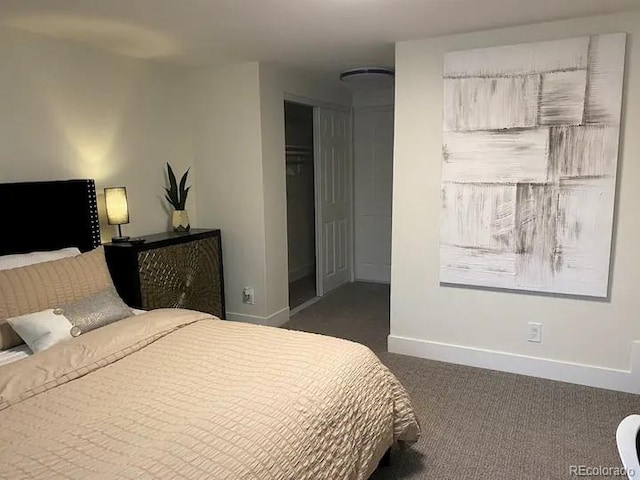 bedroom with dark carpet and a closet