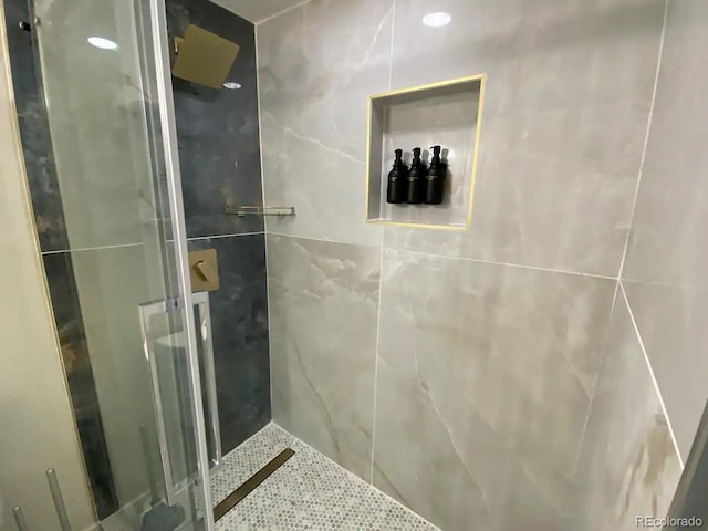 bathroom featuring a shower with shower door