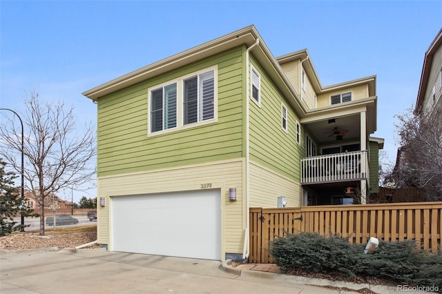 view of side of home featuring a garage and a balcony