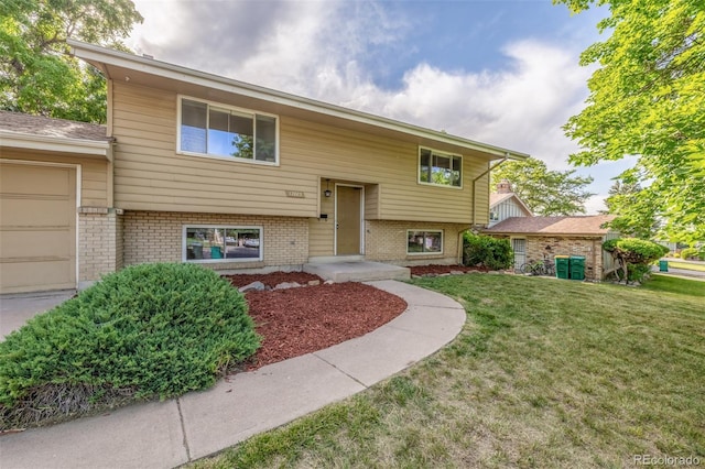 12883 E Nevada Cir, Aurora, CO 80012 - bi-level home with brick siding, a front lawn, and a garage
