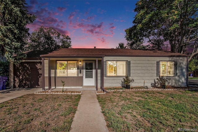 ranch-style home with a yard and driveway