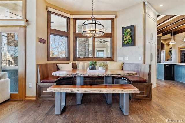 dining space with hardwood / wood-style floors, breakfast area, and a chandelier