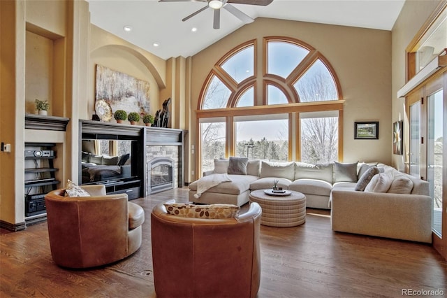 living room featuring high vaulted ceiling, plenty of natural light, dark hardwood / wood-style flooring, and ceiling fan