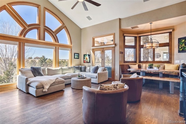 living room featuring high vaulted ceiling, dark hardwood / wood-style floors, and ceiling fan with notable chandelier