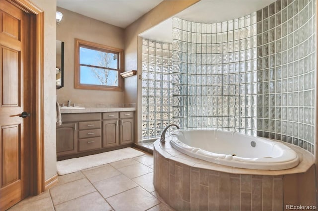 bathroom featuring tiled bath, tile patterned floors, and vanity