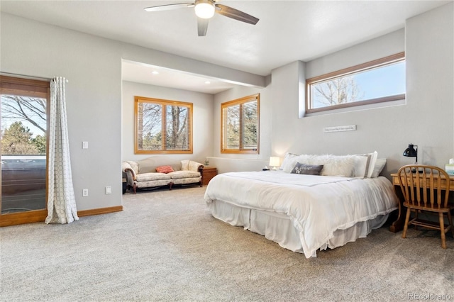 carpeted bedroom featuring ceiling fan and multiple windows