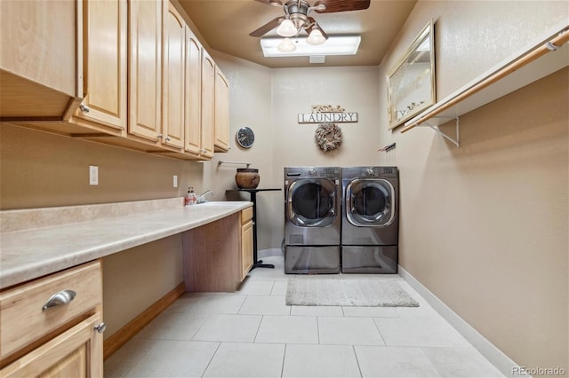 clothes washing area featuring cabinets, washing machine and clothes dryer, sink, ceiling fan, and light tile patterned floors