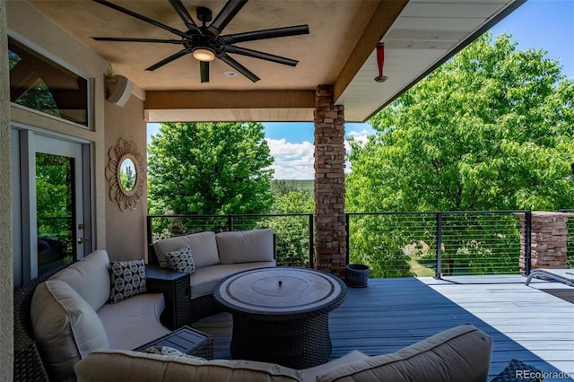 deck featuring ceiling fan and an outdoor living space