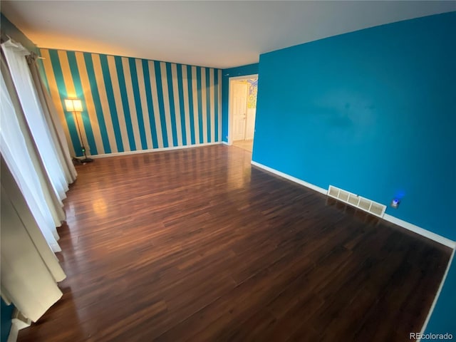 empty room featuring dark wood-type flooring