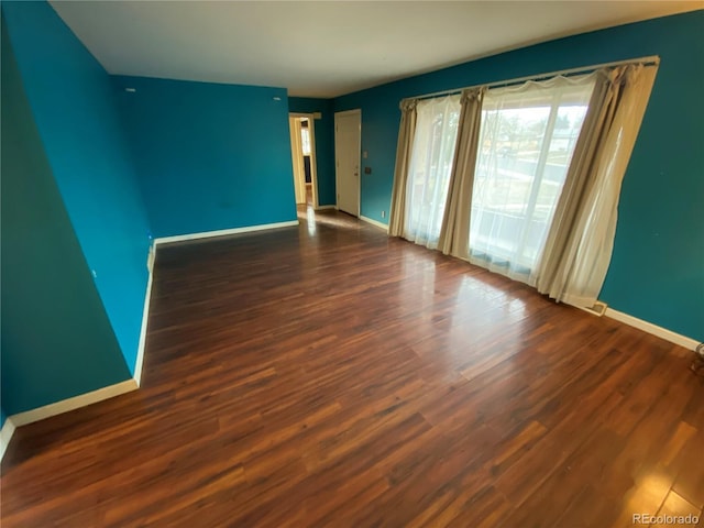 spare room with dark hardwood / wood-style flooring