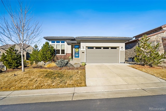 prairie-style home featuring a garage and driveway