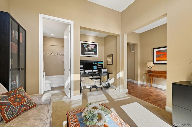 office area featuring visible vents and baseboards