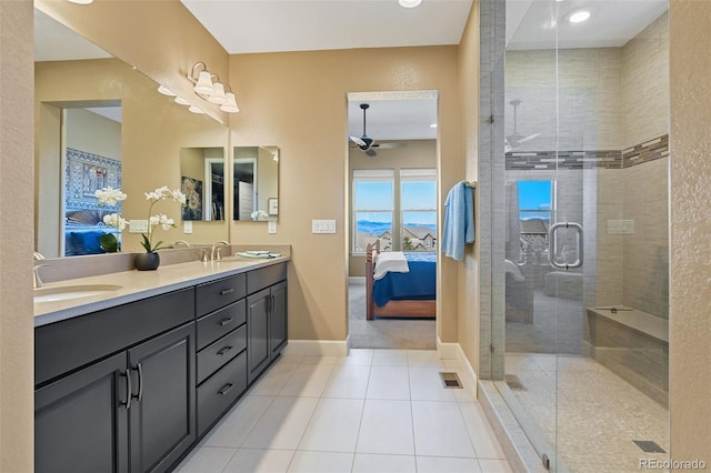 ensuite bathroom featuring a stall shower, connected bathroom, a sink, and tile patterned floors