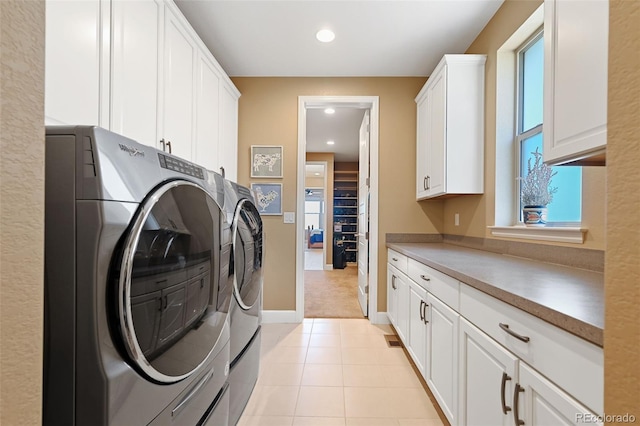 laundry room featuring light tile patterned floors, washing machine and dryer, recessed lighting, baseboards, and cabinet space