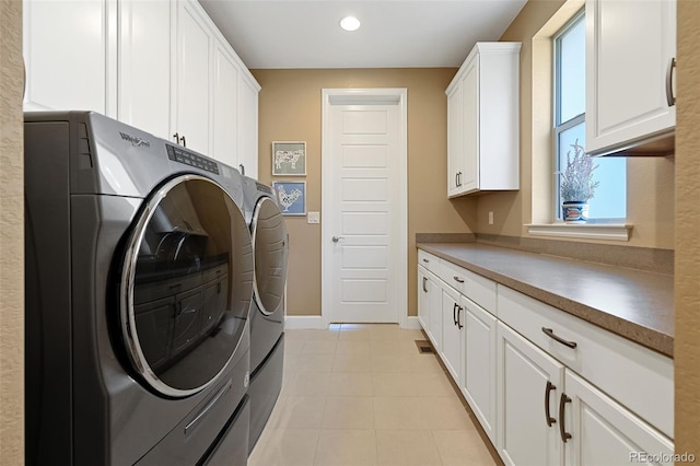 laundry room with recessed lighting, cabinet space, washing machine and dryer, light tile patterned flooring, and baseboards