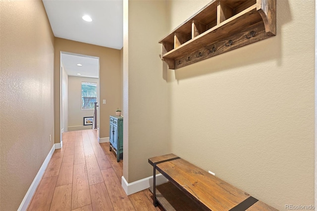 mudroom featuring light wood finished floors, recessed lighting, and baseboards