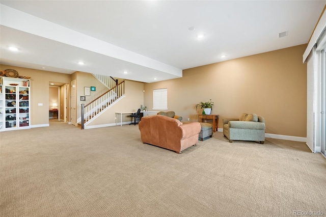 living room featuring recessed lighting, light colored carpet, baseboards, and stairs