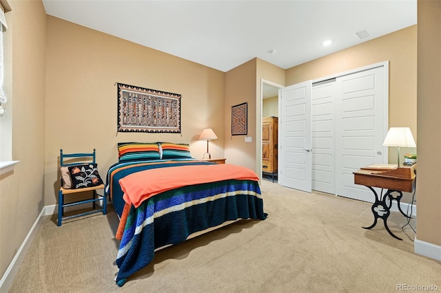 carpeted bedroom with recessed lighting, a closet, visible vents, and baseboards