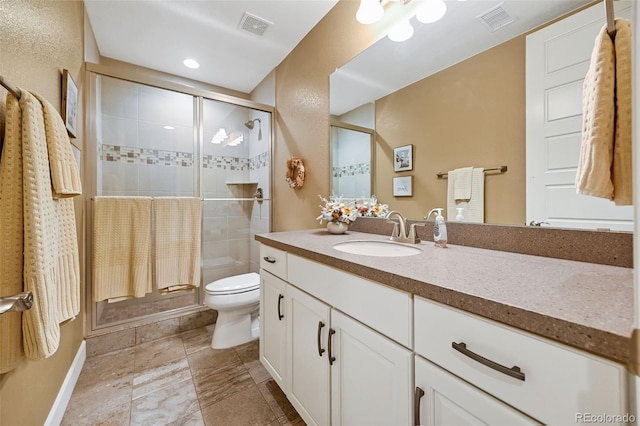 full bath featuring toilet, a stall shower, vanity, and visible vents