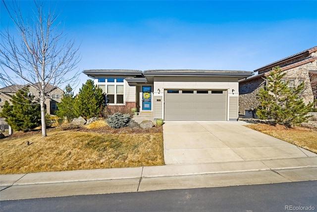prairie-style house with an attached garage and driveway