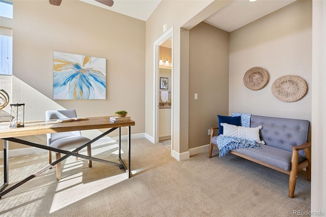 home office featuring ceiling fan, light carpet, and baseboards