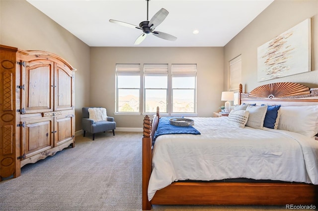 bedroom featuring baseboards, light carpet, and ceiling fan
