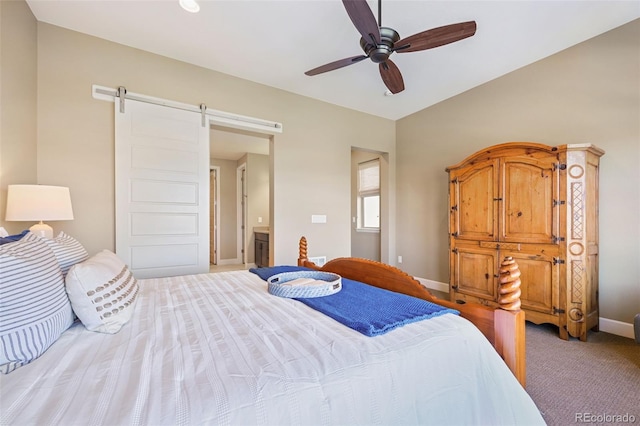 bedroom featuring baseboards, ceiling fan, a barn door, and light colored carpet