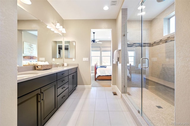 ensuite bathroom featuring connected bathroom, a sink, double vanity, visible vents, and a stall shower