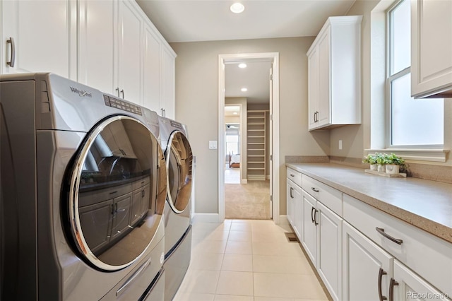 laundry room with baseboards, recessed lighting, cabinet space, independent washer and dryer, and light tile patterned floors