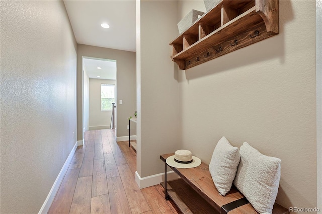 mudroom featuring baseboards, recessed lighting, and light wood-style flooring