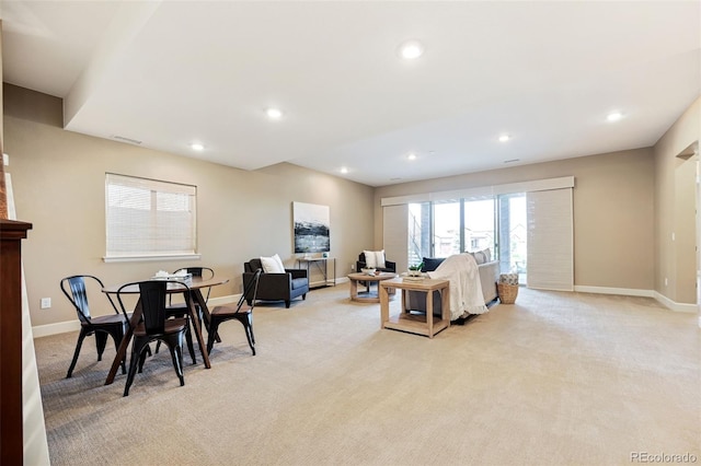 living area featuring recessed lighting, baseboards, visible vents, and light carpet