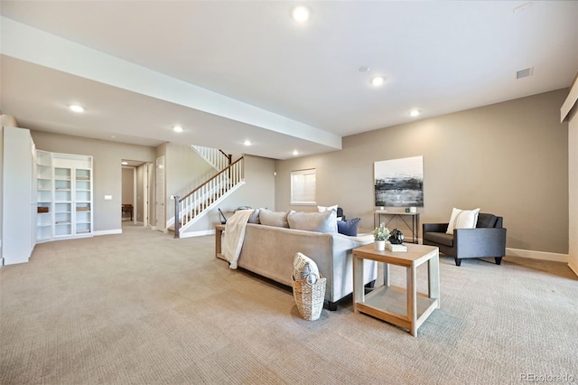living area with baseboards, recessed lighting, stairs, and light carpet