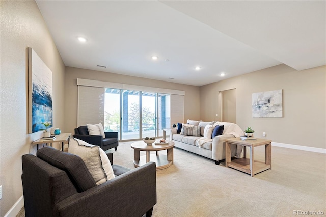 living area featuring recessed lighting, baseboards, and light carpet