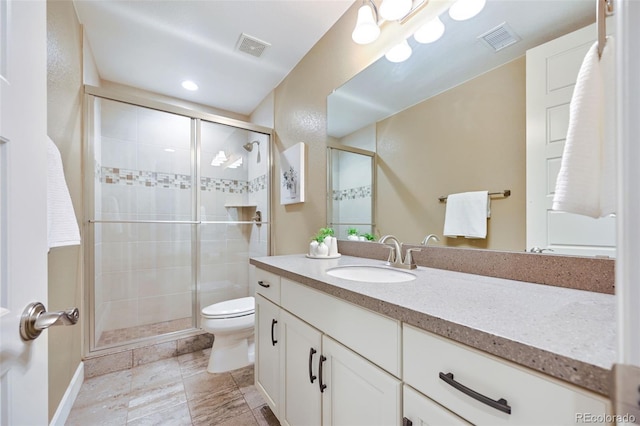 bathroom with toilet, visible vents, a shower stall, and vanity
