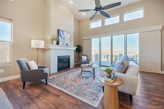 775 Woodgate Dr, Highlands Ranch, CO 80126 - living area with a towering ceiling, baseboards, hardwood / wood-style floors, and a tile fireplace