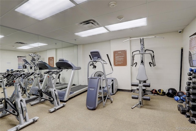 workout area with a paneled ceiling