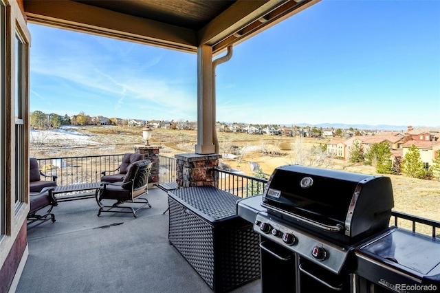 view of patio featuring a balcony and grilling area